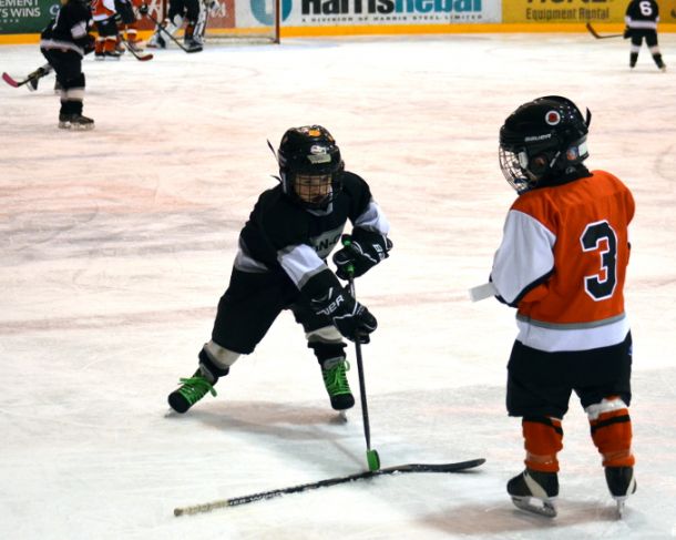 Kings Cale Oliver helps Flyers Ben Meservia get his stick 